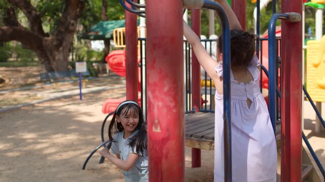 Young Thai Girl Playing on Monkey Bars at Lumpini Park Playground