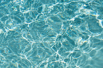 Ripped water in swimming pool. Surface of blue swimming pool, background of water.