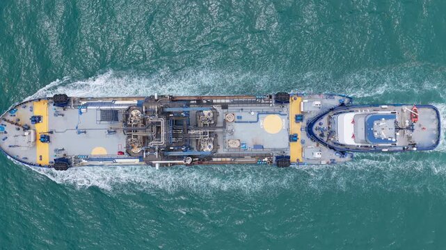Industrial petrochemical tanker. Fuel tanker vessel. Bunkering tanker aerial top view. Industrial vessel cruising through the sea. Aerial view bunkering vessel. Supplying fuel bunker