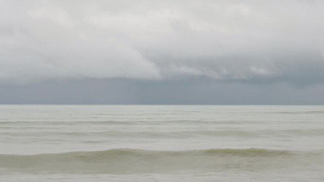 beach sea in cloudy day whilte rain and storm is coming, scary seashore scenic off Khaolak Phangnga beach  thailand with wave crashing on sandy shore Amazing travel and tour background Copy space
