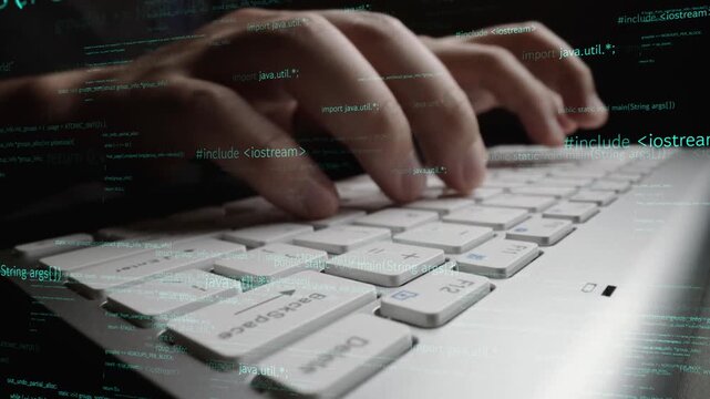 Close-up view of hands typing on a laptop keyboard, immersed in green code and programming text, illustrating the dynamic world of software development and technology. Xenic