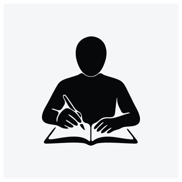 Silhouette of a student writing in a book