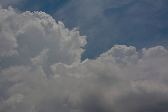 Natural background of blue sky and thick white clouds on a sunny day.