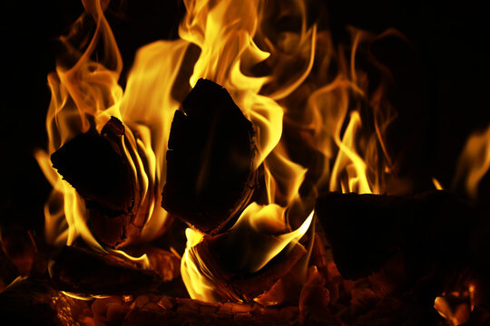 Background of the flame in the oven. Tongues of fire in a brick fireplace. Fire texture.