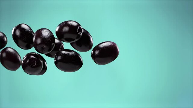 A dynamic food styling composition featuring ripe, glossy whole black olives levitating and drifting in mid-air over a vibrant cyan background. Perfect for Mediterranean food advertising, premium oliv