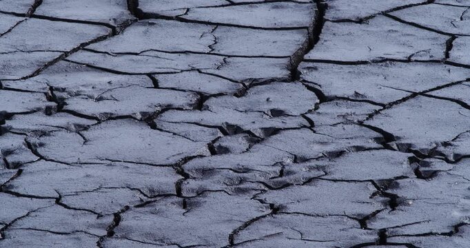 Experience the compelling sight of dry, cracked land in this video. The patterns etched in the earth serve as a reminder of nature's power and the significant impacts of prolonged drought.