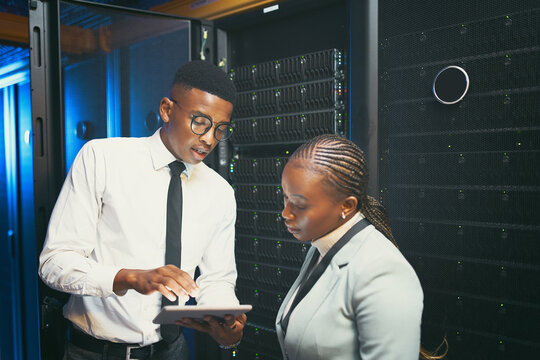 Black people, programming and meeting with tablet in server room for research, coding and cybersecurity. Team, reading or digital for software update, troubleshooting system and technical maintenance