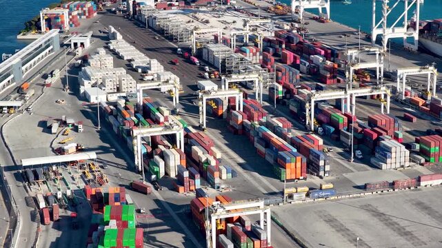 Gantry cranes moving cargo containers in a commercial port, Port Miami.