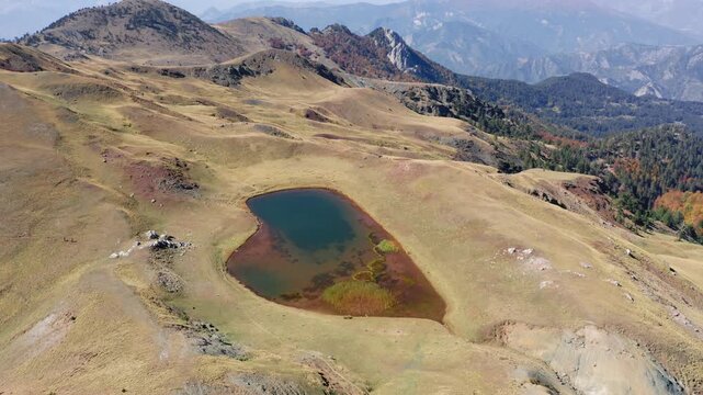 Wide-angle drone panorama of Dragon Lake (Drakolimni), Mount Smolikas, Pindus mountains, Epirus, Greece