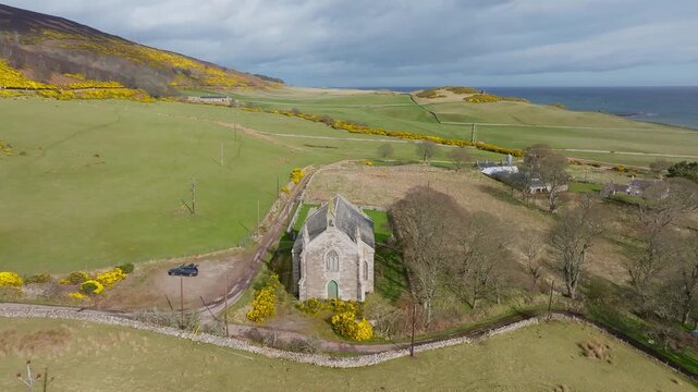 Historic Church and New Loth Burial Ground in Scottish Countryside Near Coastal Landscape