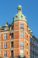 Fototapeta premium Historic Red Brick Building with Green Copper Turret, Copenhagen, Denmark