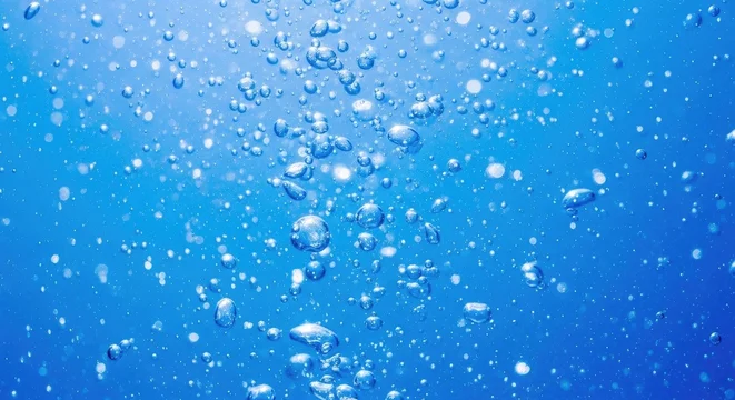Vibrant blue background with white bubbles rising