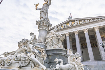 Fototapeta premium Detailed view of marble sculptures at the Pallas Athene Fountain and Austrian Parliament