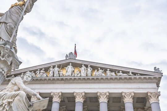 Detailed neoclassical pediment and statues of the Austrian Parliament Building in Vienna