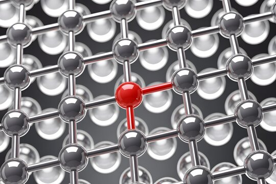 Defect in carbon atomic lattice structure with red atom