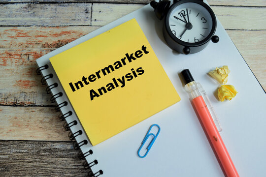 Concept of intermarket analysis write on sticky notes isolated on Wooden Table.