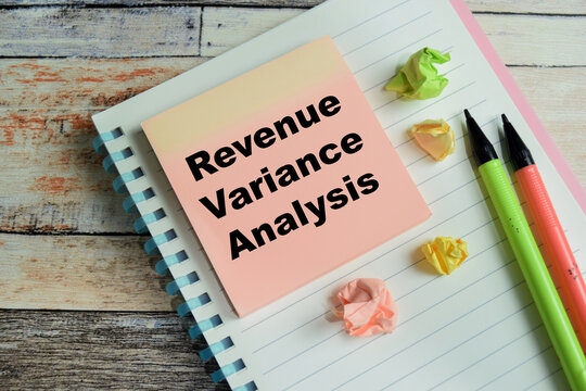 Concept of revenue variance analysis write on sticky notes isolated on Wooden Table.