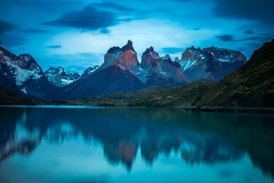 Cuernos del Paine reflected in calm lake at blue hour, Chile