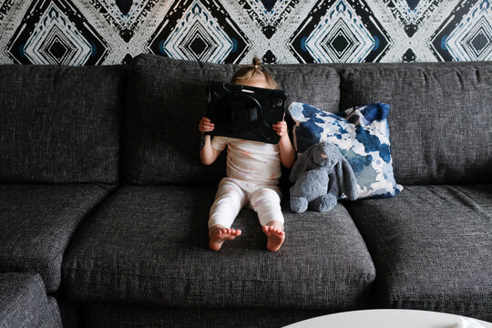Toddler enjoying screen time during vacation at hotel