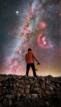 Man Looking at Stars and Milky Way with Orion Nebulae
