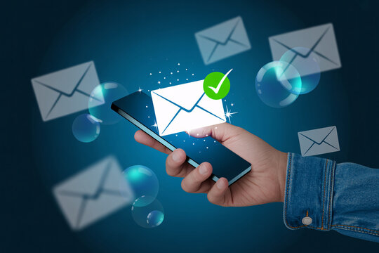 Email notification icon on smartphone with hand, mobile app and message symbols floating around