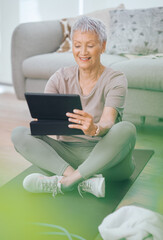 Fototapeta premium Senior, woman or research with tablet on mat in home for workout guide or online tutorial. Active, elderly or female person with smile on technology for fitness app, training tips or exercise