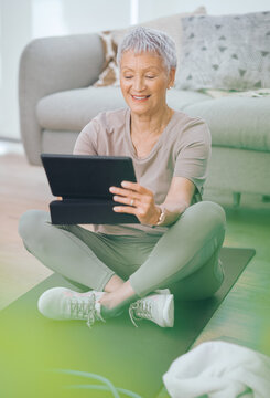 Senior, woman or research with tablet on mat in home for workout guide or online tutorial. Active, elderly or female person with smile on technology for fitness app, training tips or exercise