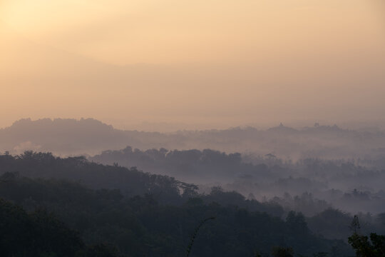 Colorful sunrise background Borobudur Temple, silhouette of Gunung Merapi, Merbabu. View from Punthuk Setumbu. Borobudur, Magelang, Central Java, Indonesia
