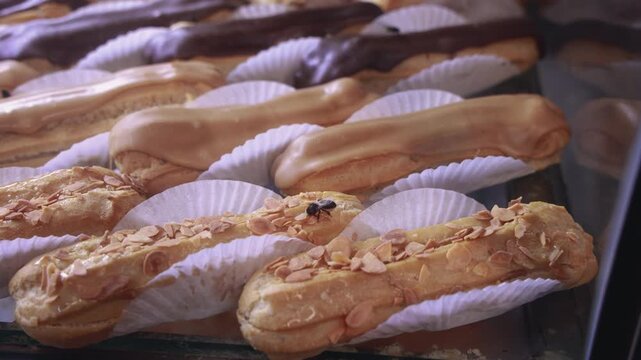 Moroccan pastry shop display with fresh &eacute;clairs and a honey bee, a traditional sign of quality and freshness in Morocco