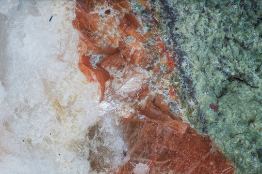 Macro image of heulandite white, stilbite orange, chlorite green zonal crystal arrangement from Vivi River, Evenkia, Russia, via microscope, 12x magnification, 3mm field of view