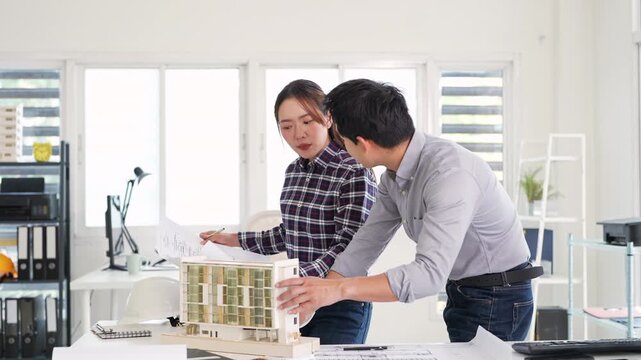 professional architects, engineers working on construction project of building .