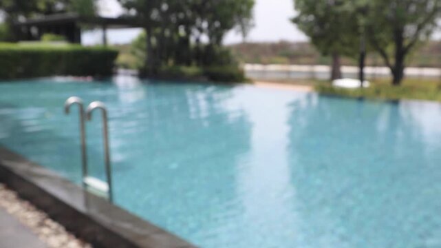 Abstract blur outdoor swimming pool in tropical resort hotel summer background