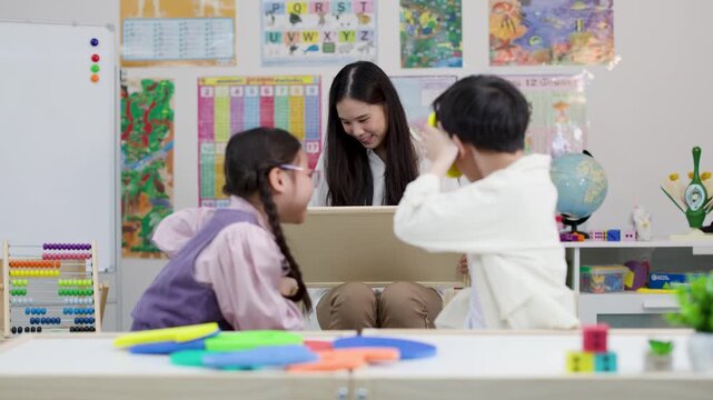 Thai Teacher and Elementary Students Learning Mathematics with Chalkboard and Shapes