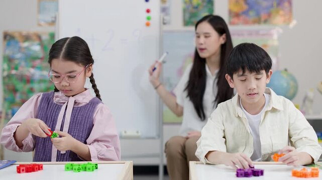 Thai Elementary Teacher and Students Learning Math with Counting Blocks