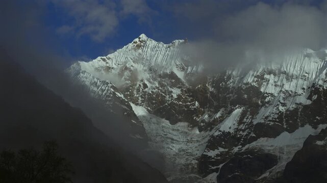 Peru's Mount Humantay Laguna Humantay hiking trailhead morning sunny fog clouds blue sky Soray Vilcabamba range Cusco Salkantay Peruvian Andes mountain Peru landscape towering snow-covered peaks pan