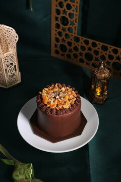 Rich chocolate cream coated cake topped with caramel glaze, nice angle view.