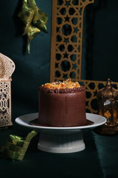 Rich chocolate cream coated cake topped with caramel glaze, nice angle view.