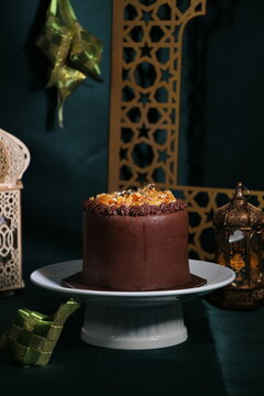 Rich chocolate cream coated cake topped with caramel glaze, nice angle view.