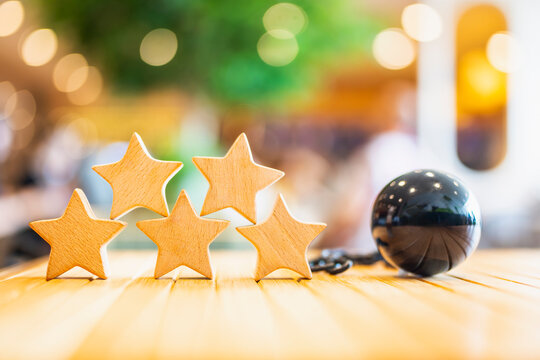Five wooden stars for credit rating with a heavy black iron ball, representing household debt burden, financial crisis impact on credit scores, and the challenge of debt management and rating.