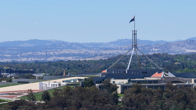 Australian Parliament House and Flagpole Under Clear Blue Sky in Canberra