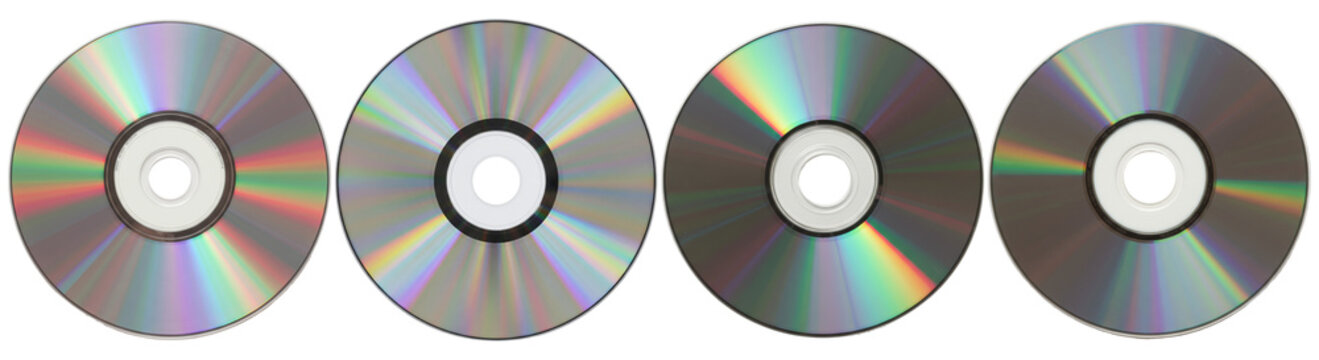 A captivating photograph showcasing a set of four shiny DVDs, highlighting their reflective surfaces and data side.