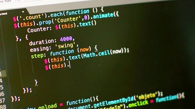 Software engineer writing a complex programming script on a dark monitor with syntax highlighting.