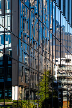 Abstract pattern on a glass office facade captures modern reflection while distortion hints at urban architecture and shifting city energy