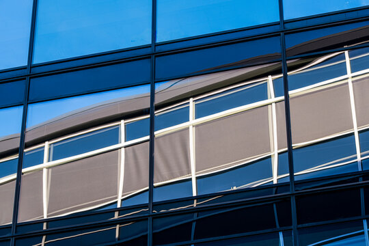 Corporate blue tones meet modern glass as lines and windows define a facade of abstract architecture pattern suited to sleek urban narratives