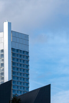 Isolated highrise building facade on clean sky with copy space minimal urban exterior architecture modern tower for real estate marketing banner