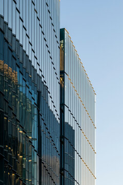 Reflective glass building facade against blue sky with copy space minimal urban exterior architecture modern pattern for corporate branding