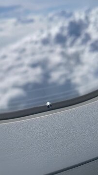 Looking out the airplane window, the clouds are incredibly beautiful, shaped like cotton candy, pure white, with a bright blue sky &mdash; perfect for animation, like Doraemon