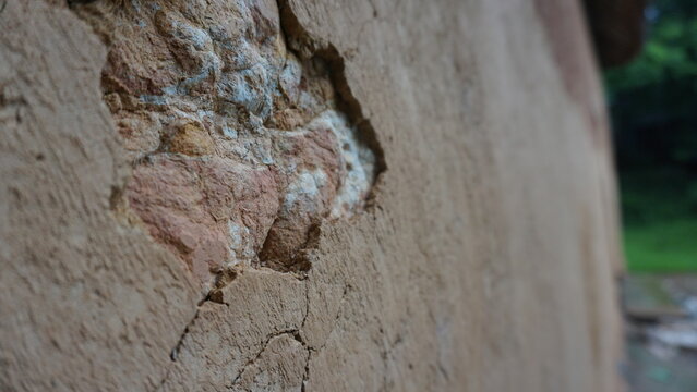 Close-up of earthen wall in traditional ethnic minority house in Vietnam, mud wall texture rustic construction detail vernacular architecture cultural heritage