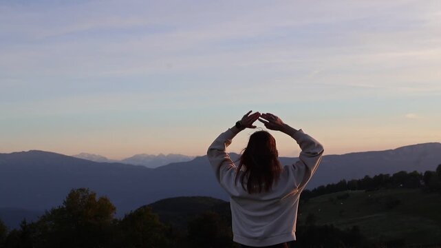 Peaceful sunset moment with woman in Italian Alps surrounded by mountains
