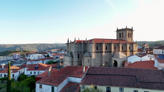 Aerial view of the historic town with its red-tiled roofs and the parish church under a clear blue sky in Torre de Moncorvo, Braganca, Portugal.